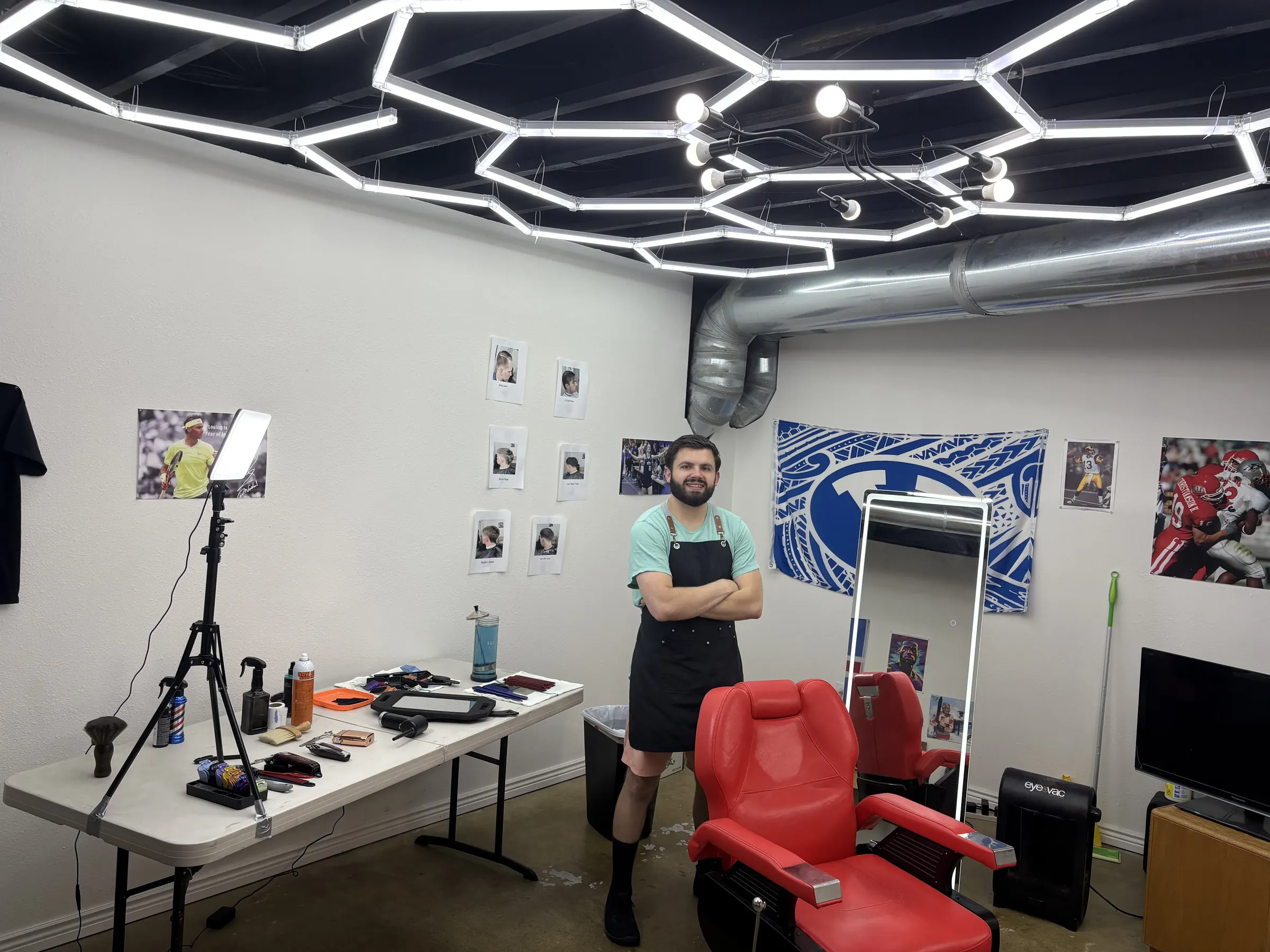 Jorun standing in his barbershop beside the barber chair
